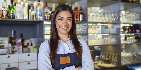 waitress wearing apron smilling looking at camera. happy businesswoman. small business owner of girl entrepreneur. cafe employee posing in restaurant coffee shop